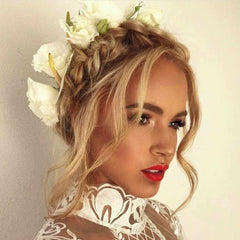 A woman wearing a floral crown featuring white and yellow flowers.